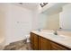 Bathroom featuring double sinks, tile flooring, and a large mirror at 8447 Amherst Valley St, Las Vegas, NV 89123