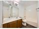Well-lit bathroom featuring a vanity with sink, toilet, and a combined bathtub and shower at 8447 Amherst Valley St, Las Vegas, NV 89123