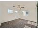 Carpeted bedroom featuring two windows and a ceiling fan at 8447 Amherst Valley St, Las Vegas, NV 89123