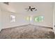 Large, bright bedroom with neutral walls, carpet flooring, ceiling fan and ample natural light at 8447 Amherst Valley St, Las Vegas, NV 89123