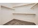 Walk-in closet featuring carpeted floor and multiple wooden rails for hanging clothes at 8447 Amherst Valley St, Las Vegas, NV 89123