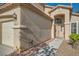 Close-up of the front entrance and side of the 3 car garage, showing the stucco finish at 8447 Amherst Valley St, Las Vegas, NV 89123