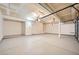 An empty and clean garage with three ceiling mounted lights at 8447 Amherst Valley St, Las Vegas, NV 89123