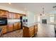 Open concept kitchen with wood cabinets, granite countertops and stainless steel appliances at 8447 Amherst Valley St, Las Vegas, NV 89123