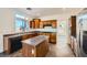 Well-equipped kitchen featuring an island, gas range, ample cabinet space, and granite countertops at 8447 Amherst Valley St, Las Vegas, NV 89123