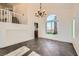 Cozy living area with tile flooring, an open staircase, and natural light streaming through a large window at 8447 Amherst Valley St, Las Vegas, NV 89123