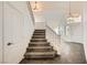 Inviting foyer and staircase featuring neutral decor, tiled floors, and natural light at 8447 Amherst Valley St, Las Vegas, NV 89123