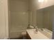 Bathroom featuring a white vanity with tub and shower at 8584 Garnet Lake Ave, Las Vegas, NV 89113