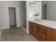 Bright bathroom featuring a double vanity, large mirror, and walk-in shower at 8584 Garnet Lake Ave, Las Vegas, NV 89113
