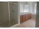 Bathroom with glass shower, double sinks, a large mirror and tiled floor at 8584 Garnet Lake Ave, Las Vegas, NV 89113
