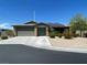 Charming single-story home with a two-car garage, desert landscaping, and solar panels at 8584 Garnet Lake Ave, Las Vegas, NV 89113