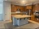 Bright kitchen with granite counters, stainless appliances, island, and tile flooring at 8584 Garnet Lake Ave, Las Vegas, NV 89113