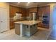 Well-appointed kitchen boasts granite countertops, an island, and stainless steel appliances at 8584 Garnet Lake Ave, Las Vegas, NV 89113