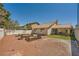 Spacious backyard featuring a covered patio and raised garden beds, perfect for outdoor entertaining and gardening at 100 Underhill Ct, Las Vegas, NV 89145