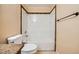 Bathroom with a tub-shower combo, tile accents, and a modern toilet at 100 Underhill Ct, Las Vegas, NV 89145