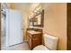 A bathroom showcasing a granite sink, framed mirror, and a toilet at 100 Underhill Ct, Las Vegas, NV 89145