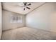 Spacious bedroom featuring a ceiling fan, carpet flooring, and a window with blinds at 100 Underhill Ct, Las Vegas, NV 89145