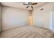 Bright bedroom with carpet, ceiling fan, and an open view of the ensuite bathroom at 100 Underhill Ct, Las Vegas, NV 89145