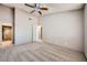 Large bedroom featuring carpet flooring, an interior door, and a ceiling fan at 100 Underhill Ct, Las Vegas, NV 89145