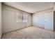 A bedroom featuring neutral walls and carpet, and a window with natural light at 100 Underhill Ct, Las Vegas, NV 89145