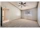 Bedroom featuring carpet flooring, a ceiling fan, a window with blinds, and an interior door at 100 Underhill Ct, Las Vegas, NV 89145