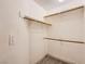 Walk-in closet with wood shelving and new carpet at 100 Underhill Ct, Las Vegas, NV 89145