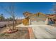 Charming two-story home with a two-car garage and desert landscaping in a bright, sunny setting at 100 Underhill Ct, Las Vegas, NV 89145