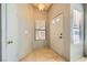 Inviting foyer featuring tile flooring, a front door with windows, and a side closet at 100 Underhill Ct, Las Vegas, NV 89145