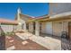 Front entrance with security door and porch area, surrounded by well-maintained landscaping at 100 Underhill Ct, Las Vegas, NV 89145