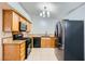 Well-lit kitchen equipped with modern black appliances, wooden cabinets, and light countertops at 100 Underhill Ct, Las Vegas, NV 89145