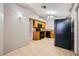Open kitchen featuring black appliances, wooden cabinets, tile flooring, and views into other rooms at 100 Underhill Ct, Las Vegas, NV 89145