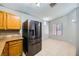 Spacious kitchen featuring stainless steel refrigerator, wooden cabinets, and light-colored countertops at 100 Underhill Ct, Las Vegas, NV 89145