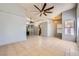Open-concept living room with neutral colors, tile flooring, and ceiling fans at 100 Underhill Ct, Las Vegas, NV 89145