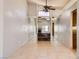 Open-concept living room with tile flooring and partial mirrored wall at 100 Underhill Ct, Las Vegas, NV 89145