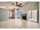 Cozy living room featuring tile flooring, a fireplace, and sliding glass doors for natural light at 100 Underhill Ct, Las Vegas, NV 89145