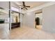 Bright living room with tile floors, view to kitchen, and a ceiling fan at 100 Underhill Ct, Las Vegas, NV 89145
