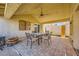A covered patio with stylish tiled flooring and comfortable seating at 100 Underhill Ct, Las Vegas, NV 89145