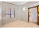 Bright room with tile flooring, a window with blinds, and views into other rooms at 100 Underhill Ct, Las Vegas, NV 89145