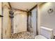 The remodeled shower stall features designer tile work, a full body shower, and built-in shelving at 100 Underhill Ct, Las Vegas, NV 89145