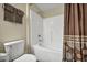 Bathroom featuring a white toilet and a shower-tub combination with patterned curtains at 10550 W Alexander Rd # 2103, Las Vegas, NV 89129