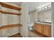 Bathroom featuring a vanity with wood cabinetry, toilet, and built-in shelving at 10550 W Alexander Rd # 2103, Las Vegas, NV 89129
