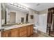 Well-lit bathroom with double vanity, granite counters, and a shower-tub combination at 10550 W Alexander Rd # 2103, Las Vegas, NV 89129