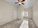 Bright bedroom features plush carpeting, a ceiling fan, and a large window for natural light at 10550 W Alexander Rd # 2103, Las Vegas, NV 89129