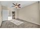 Bedroom with neutral carpet, ceiling fan, and ensuite bathroom access at 10550 W Alexander Rd # 2103, Las Vegas, NV 89129
