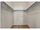 Walk-in closet offering ample storage space with wood rods for hanging clothes at 10550 W Alexander Rd # 2103, Las Vegas, NV 89129