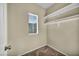 A walk-in closet provides shelving and a window for ample storage and natural light at 10550 W Alexander Rd # 2103, Las Vegas, NV 89129