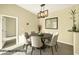 Cozy dining room with a round table, modern light fixture, and neutral decor at 10550 W Alexander Rd # 2103, Las Vegas, NV 89129