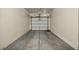 Two car garage with freshly painted walls and a white garage door at 10550 W Alexander Rd # 2103, Las Vegas, NV 89129