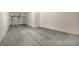 A spacious garage with concrete flooring offers ample parking and storage space at 10550 W Alexander Rd # 2103, Las Vegas, NV 89129