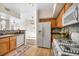 Bright kitchen with wooden cabinets, white appliances, and eat-in nook at 10550 W Alexander Rd # 2103, Las Vegas, NV 89129